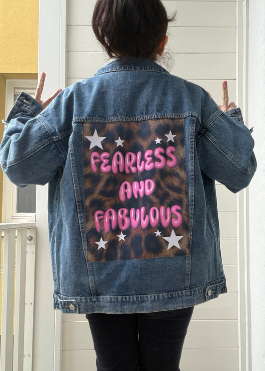 Person wearing a denim jacket with 'Fearless and Fabulous' text on the back