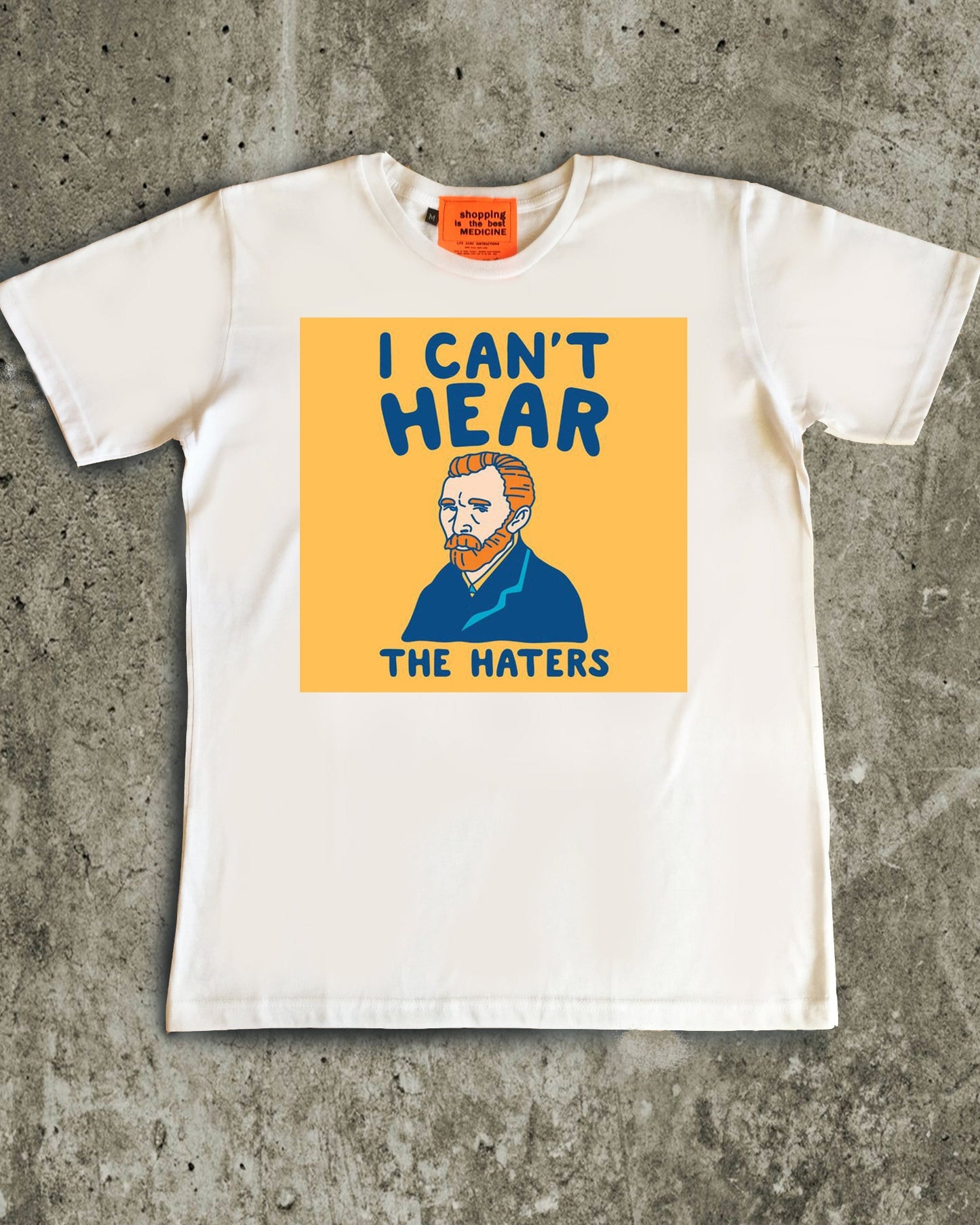 White t-shirt with a graphic design on a concrete surface