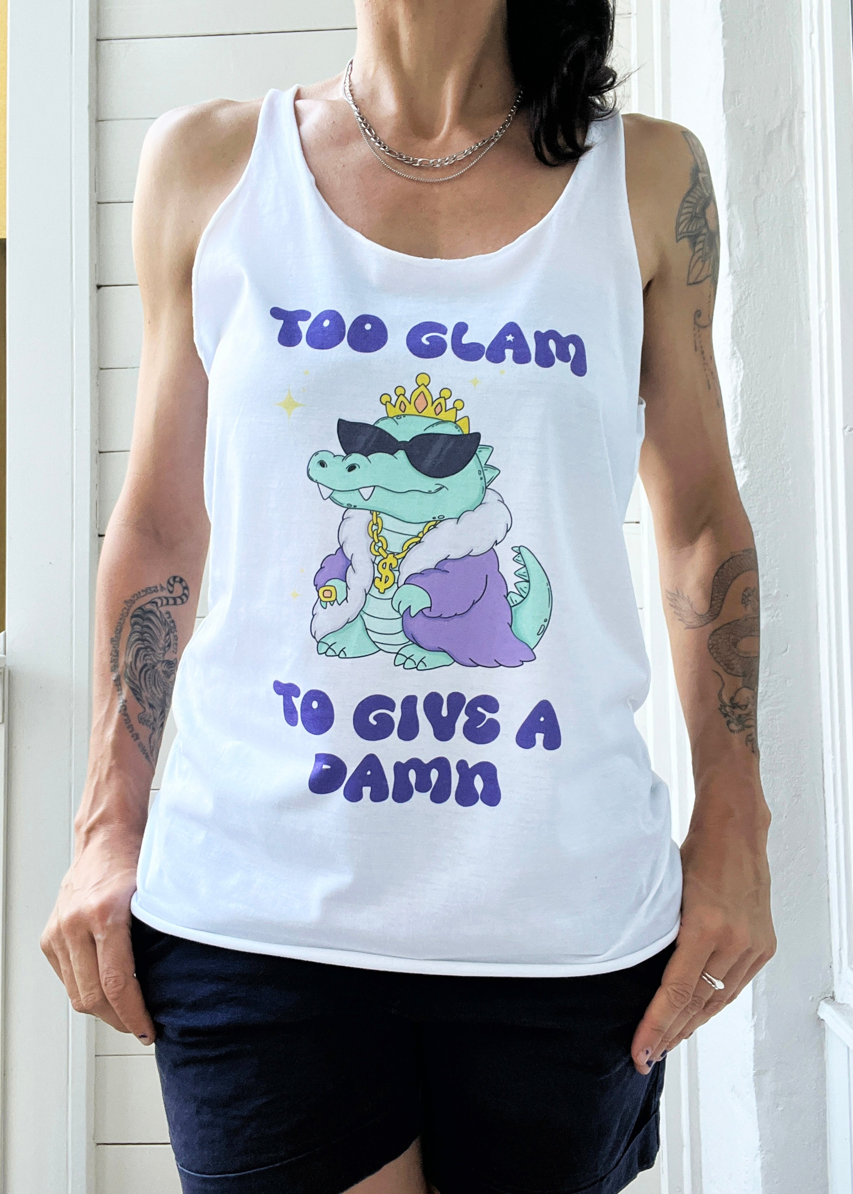 Person wearing a white tank top with a graphic design and text.
