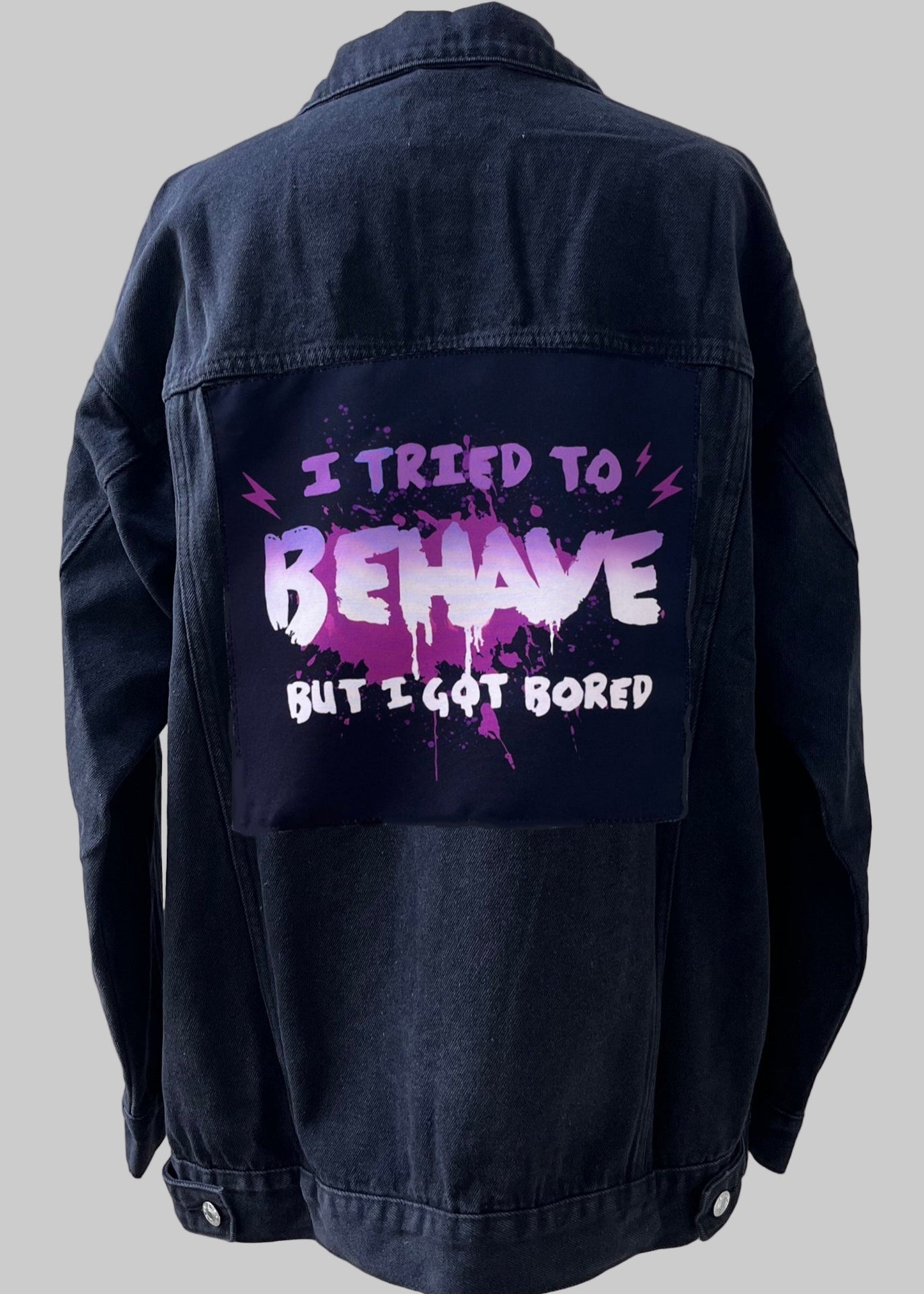 Denim jacket with handmade fabric patch artwork on back