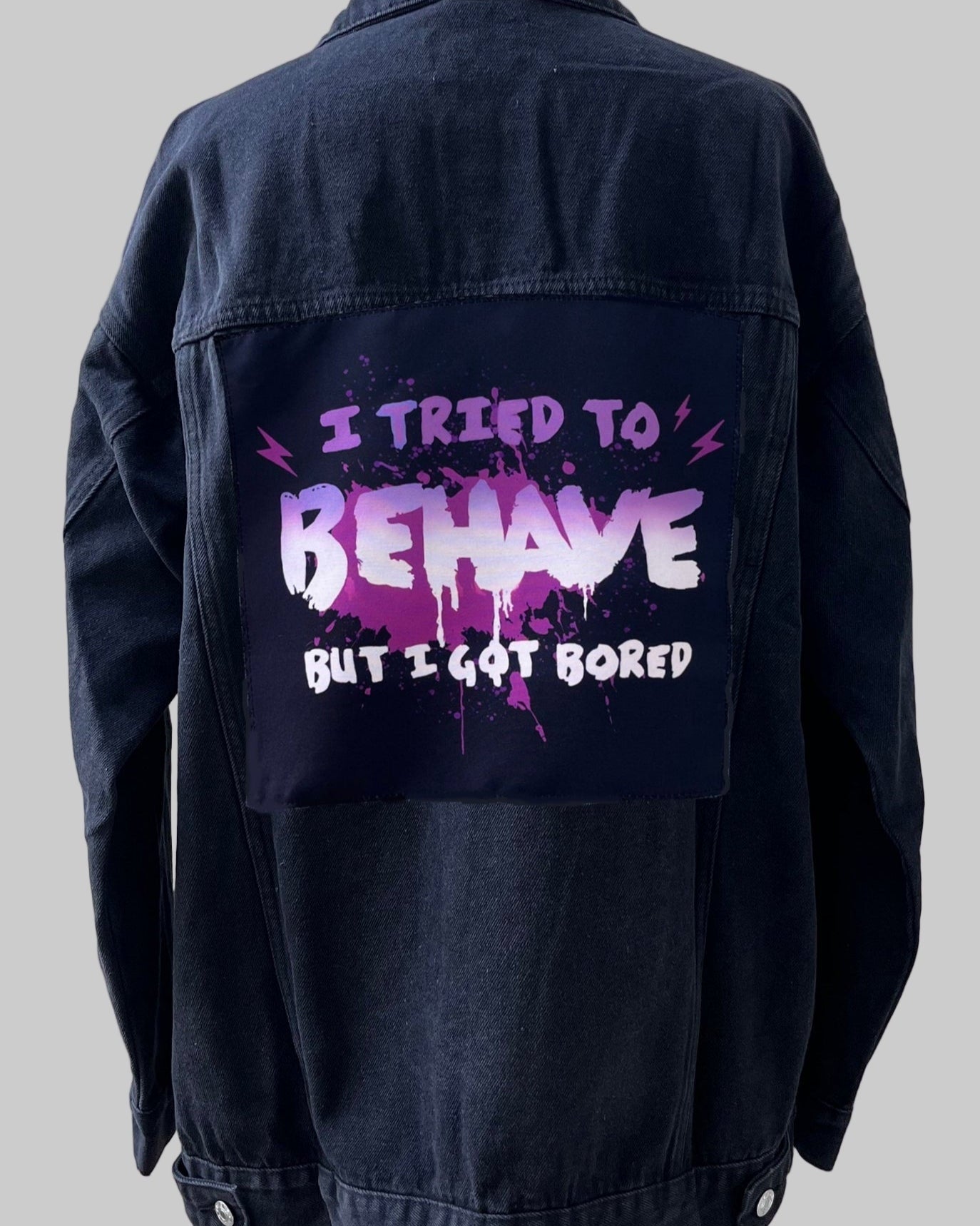 Denim jacket with handmade fabric patch artwork on back