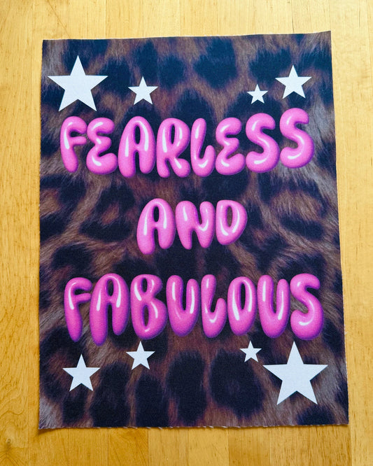 Leopard print poster with 'Fearless and Fabulous' text on a wooden surface