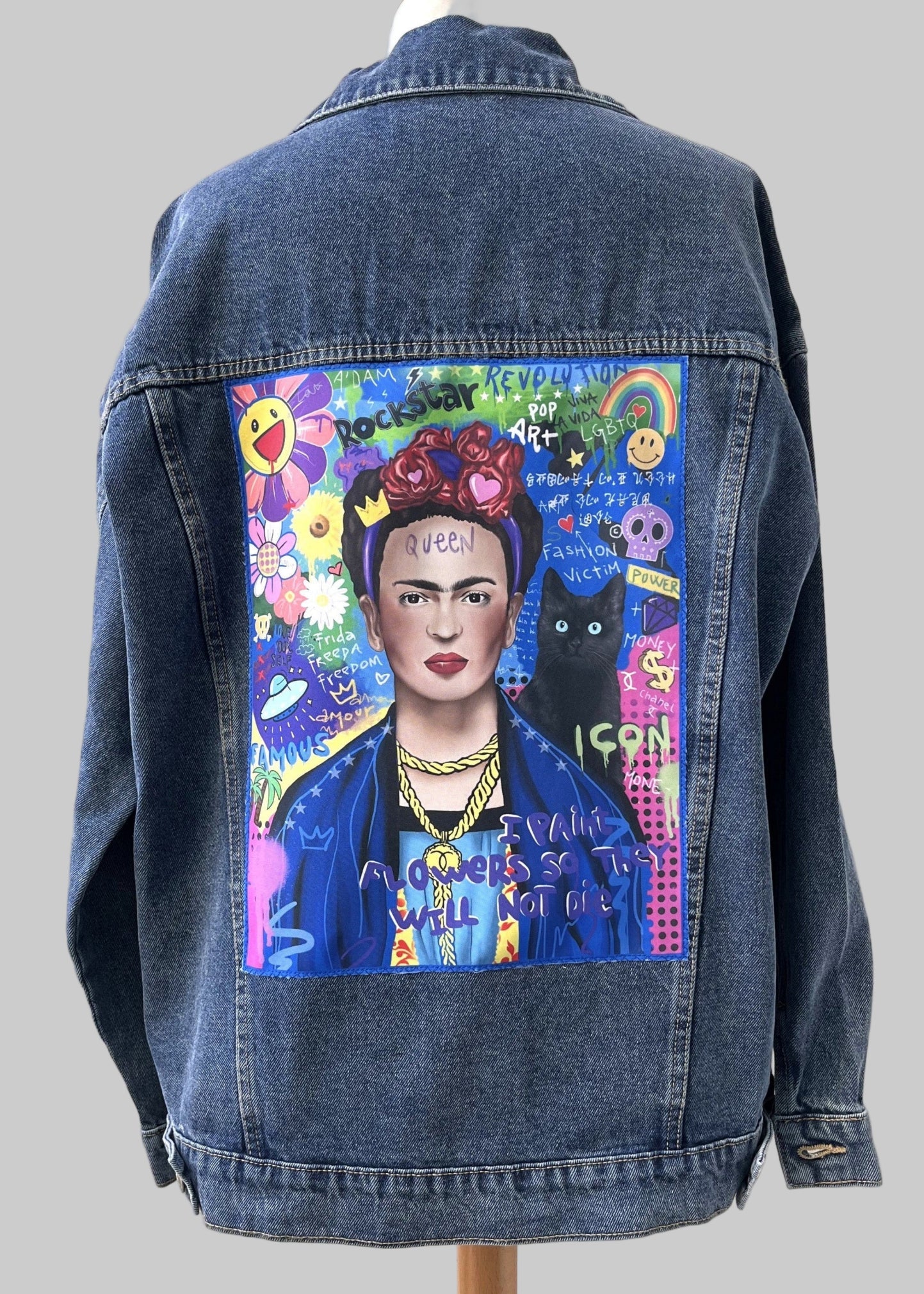 Denim jacket with a colorful painting of a famous artist on a mannequin against a white wall.
