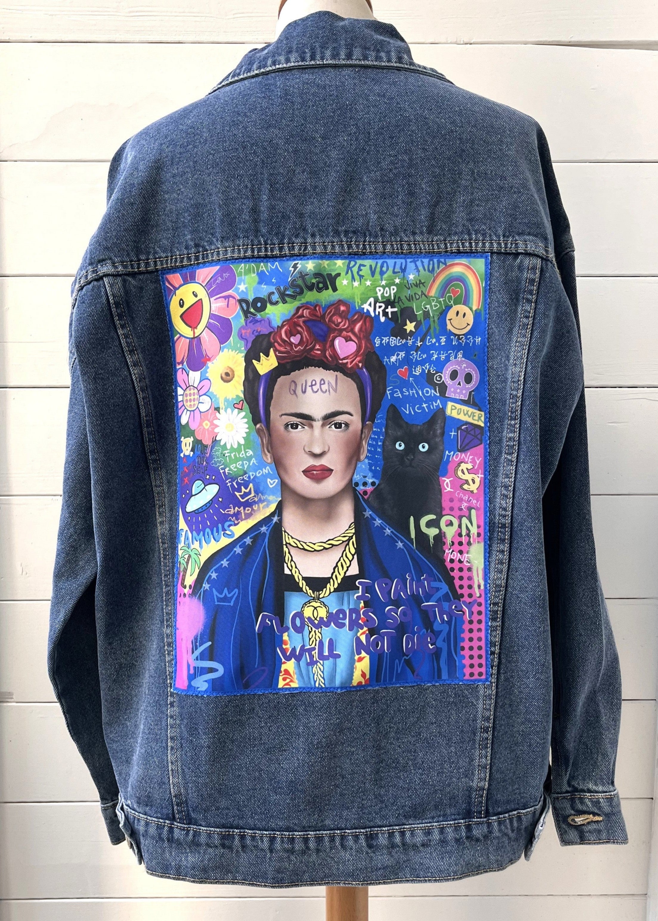 Denim jacket with a colorful painting of a famous artist on a mannequin against a white wall.