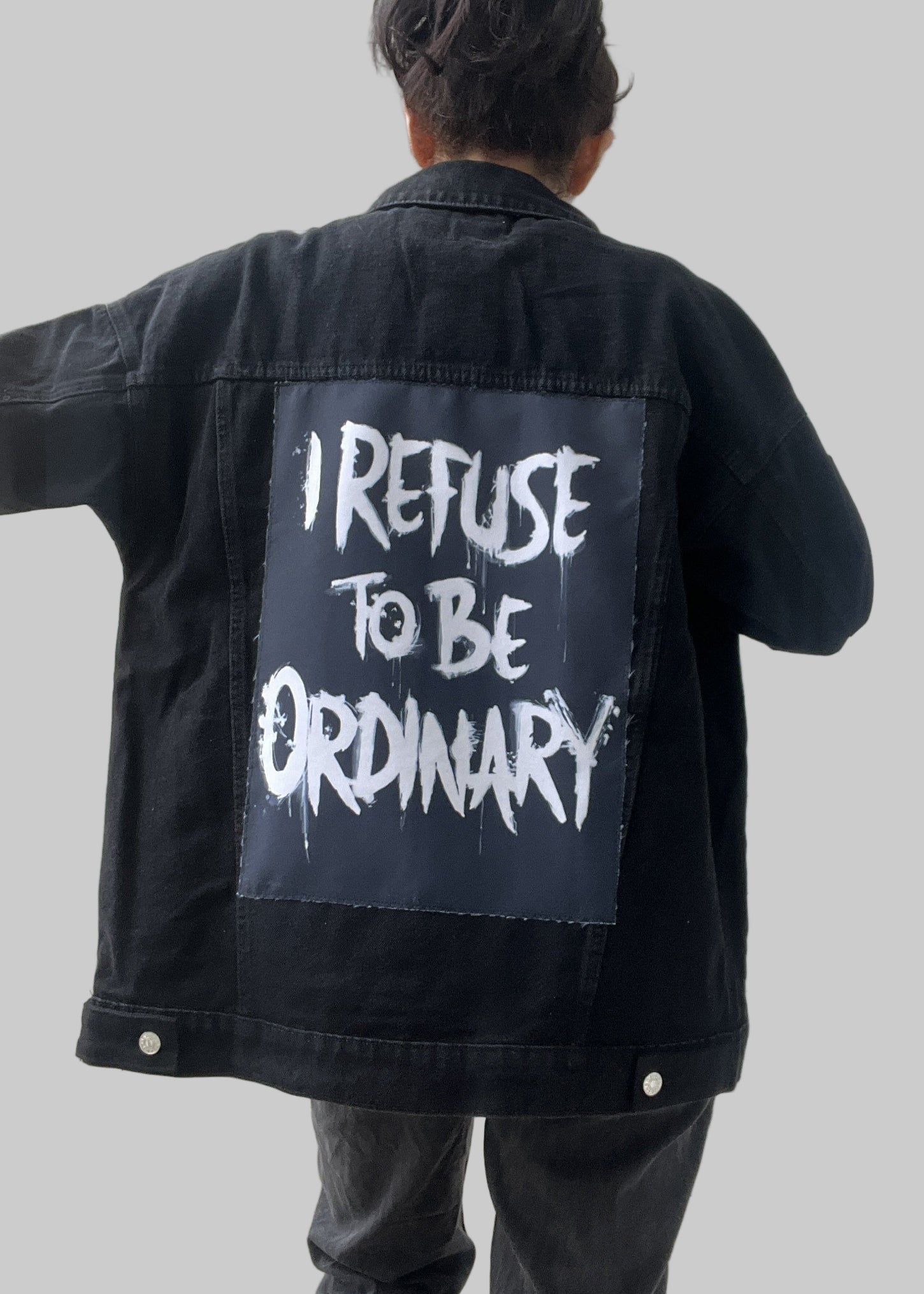 Denim jacket with handmade fabric patch artwork on back