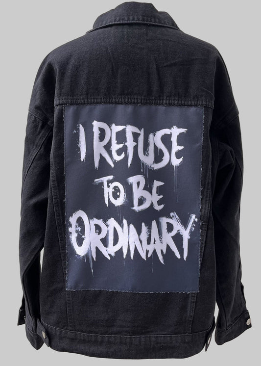 Denim jacket with handmade fabric patch artwork on back