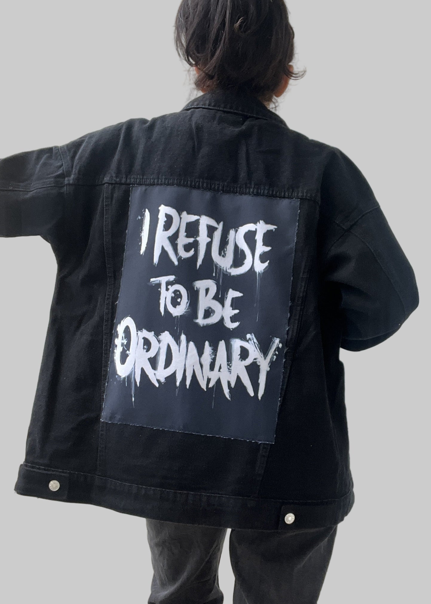 Denim jacket with handmade fabric patch artwork on back patch