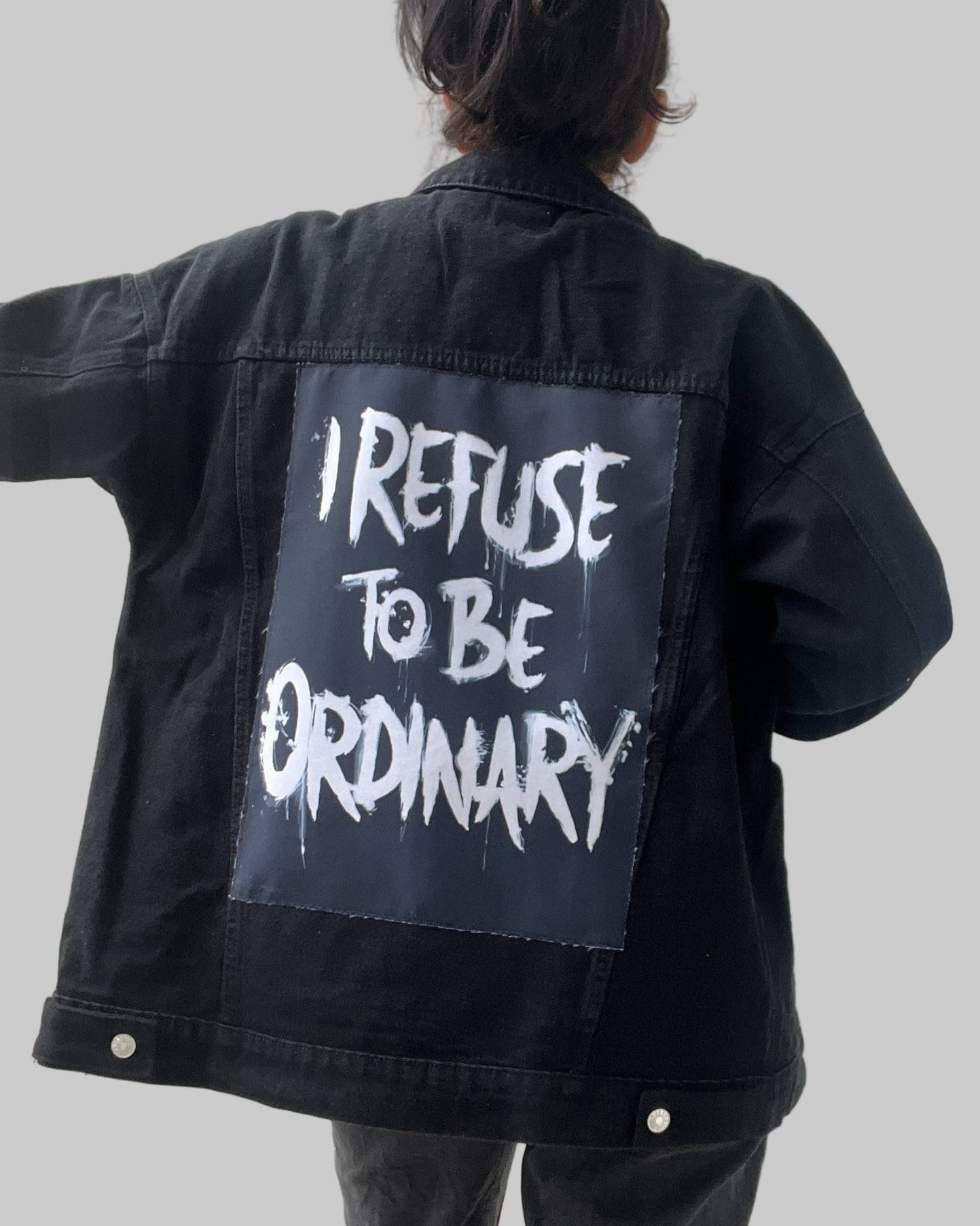 Denim jacket with handmade fabric patch artwork on back patch