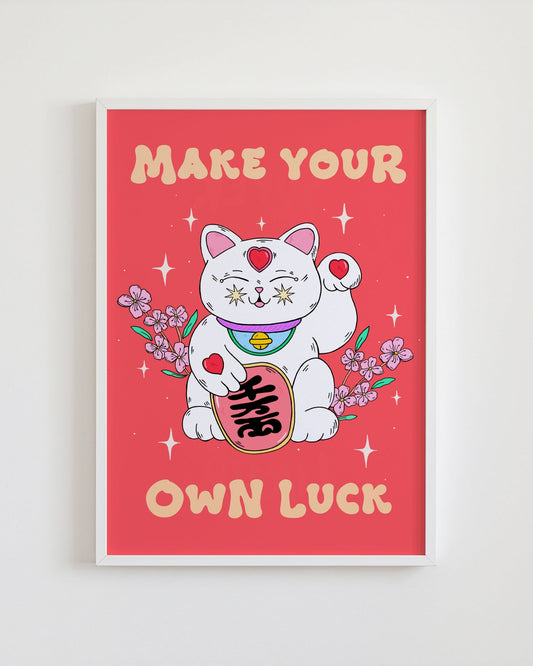 Framed poster with a cartoon cat holding flowers and text 'Make Your Own Luck' on a red background.