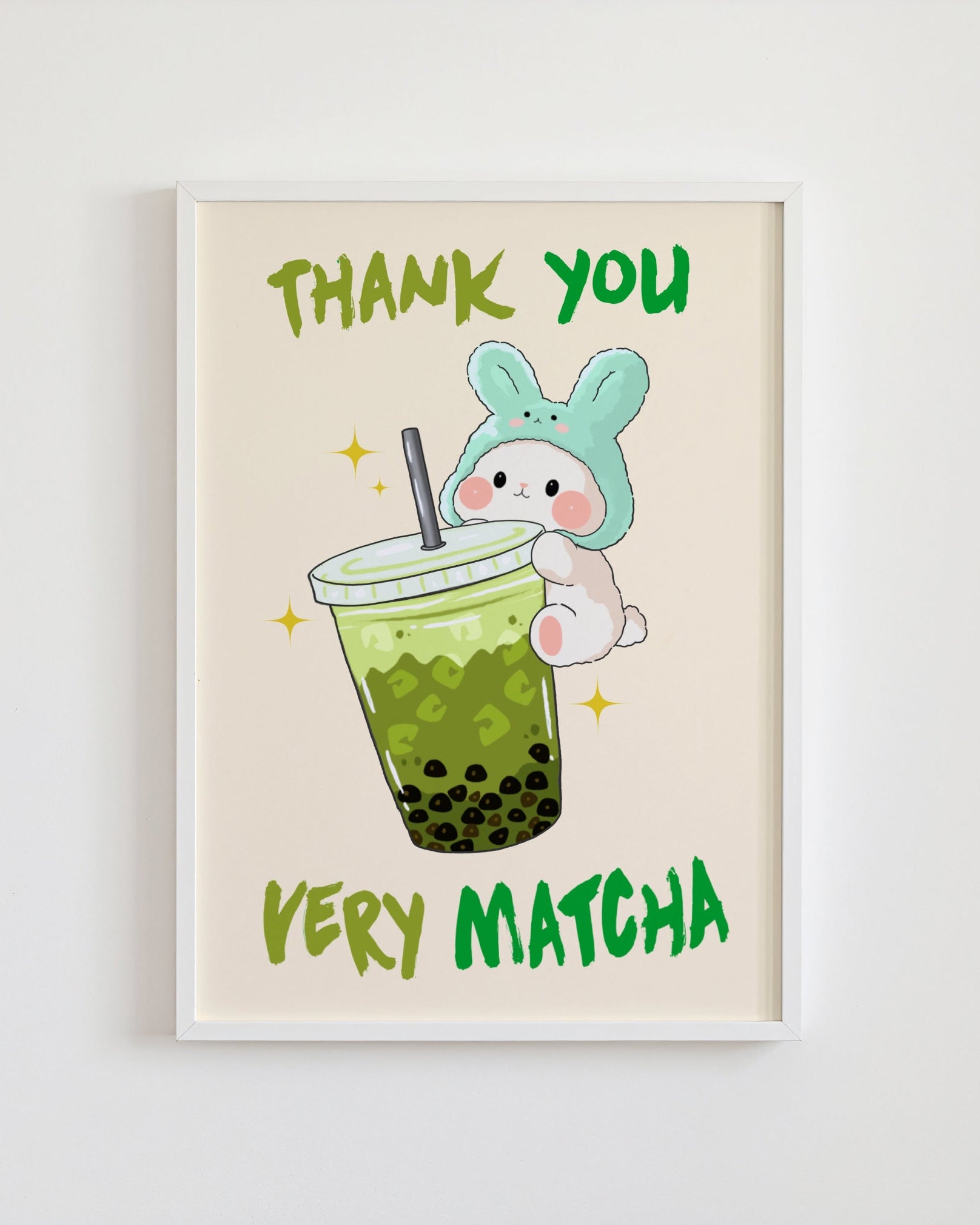 Framed artwork with a cartoon bunny holding a green bubble tea and 'Thank you very matcha' text on a beige background.