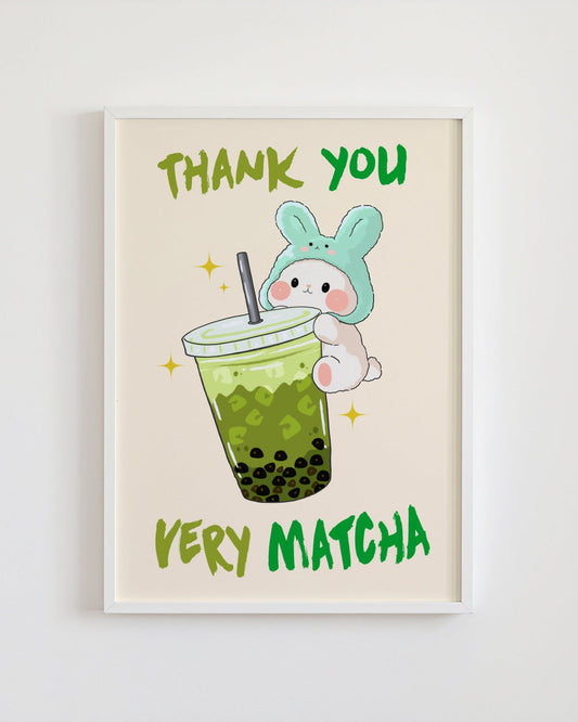 Framed artwork with a cartoon bunny holding a green bubble tea and 'Thank you very matcha' text on a beige background.