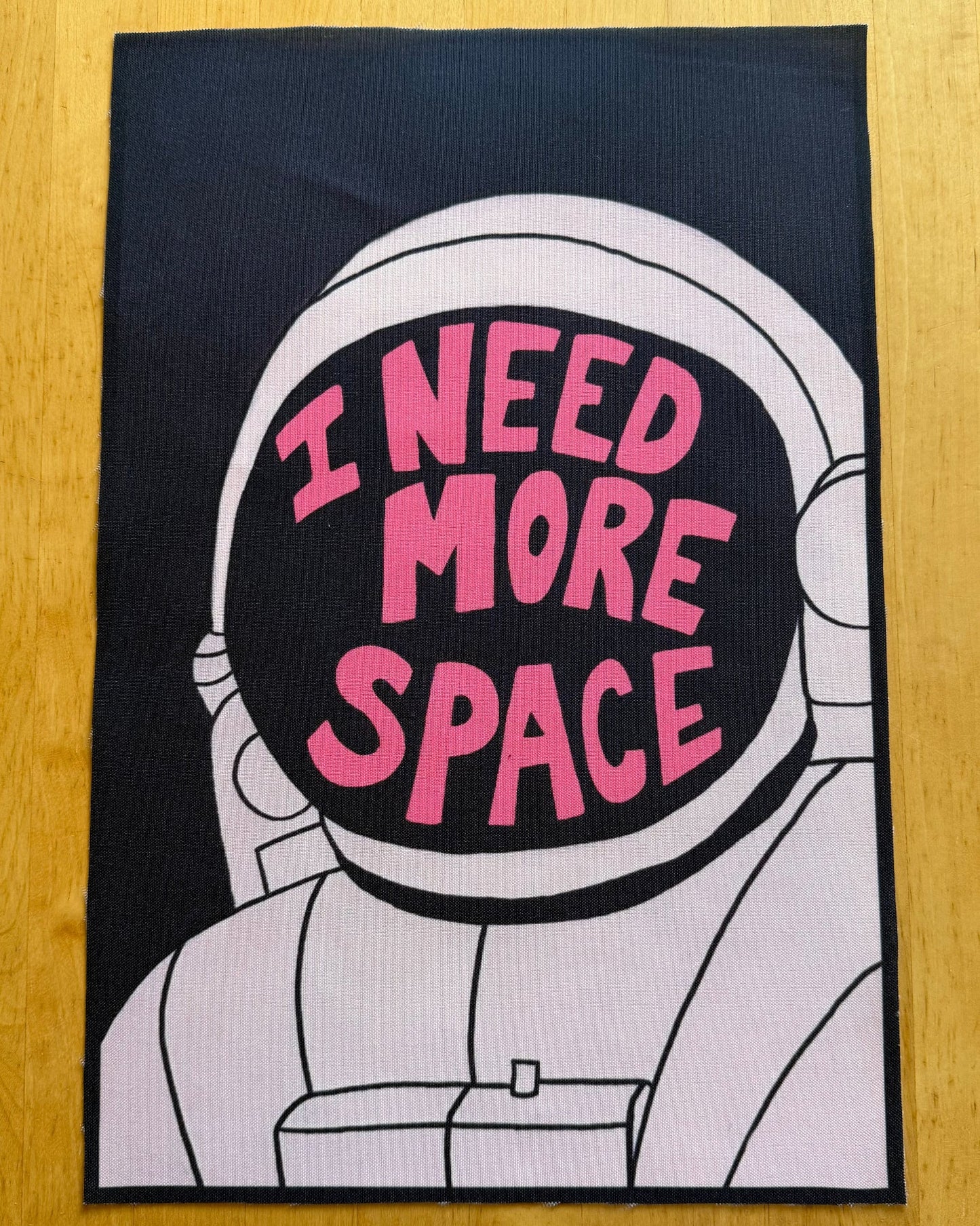 Astronaut graphic with 'I Need More Space' text on a black background