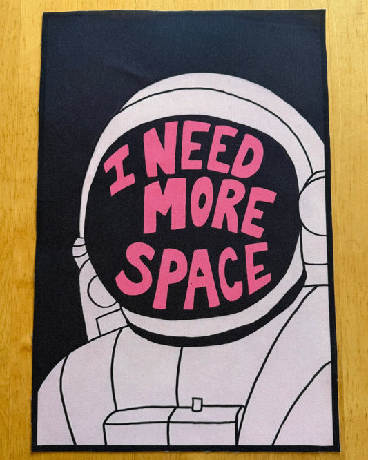 Astronaut graphic with 'I Need More Space' text on a black background