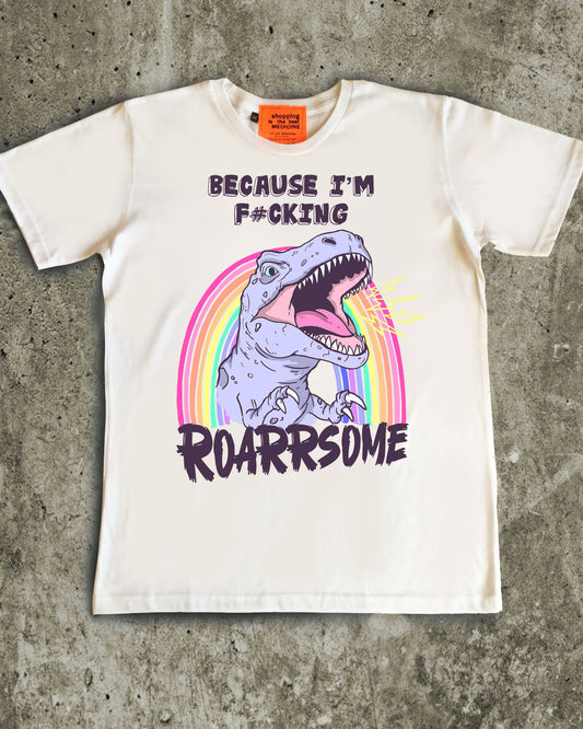 White t-shirt with dinosaur graphic and text on a concrete surface