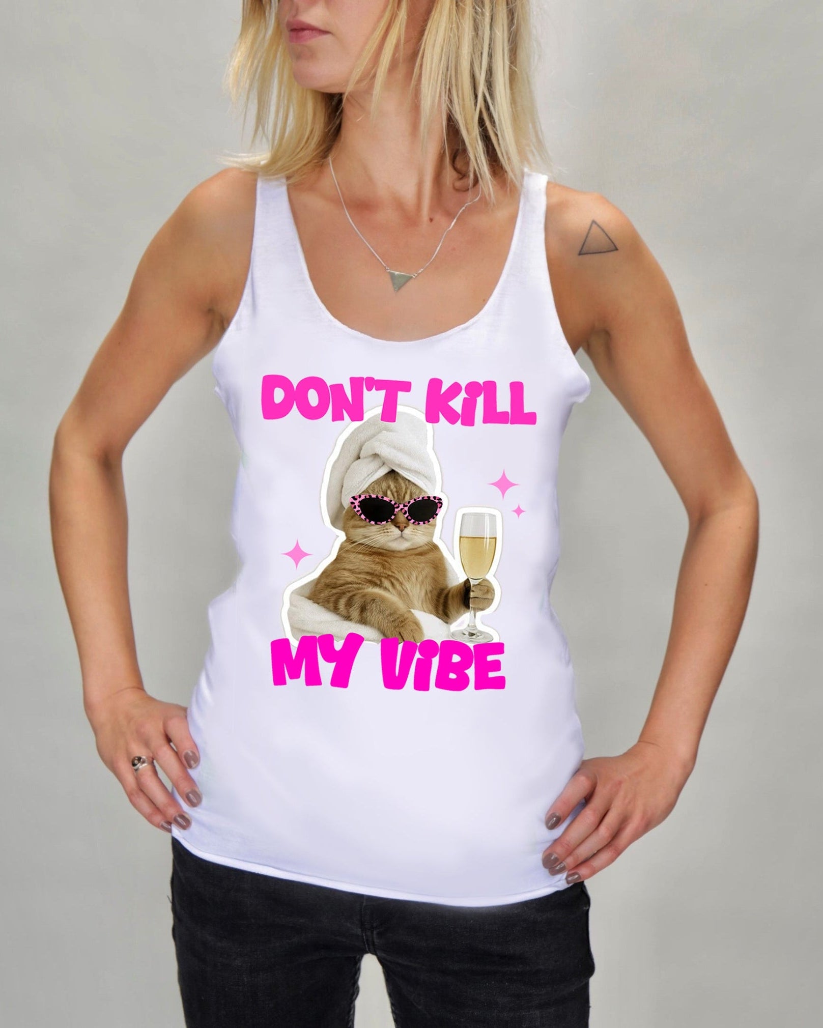 A woman wearing a white tank top with a graphic print of a cat in sunglasses and a towel holding a glass of champagne, with the text 'DON'T KILL MY VIBE' in pink.