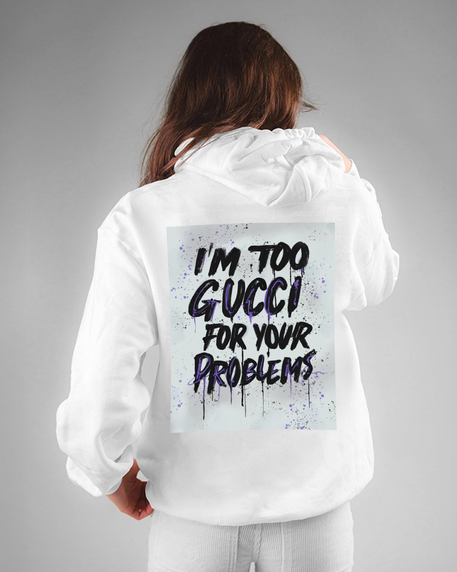 Person wearing a white hoodie with text on the back against a gray background