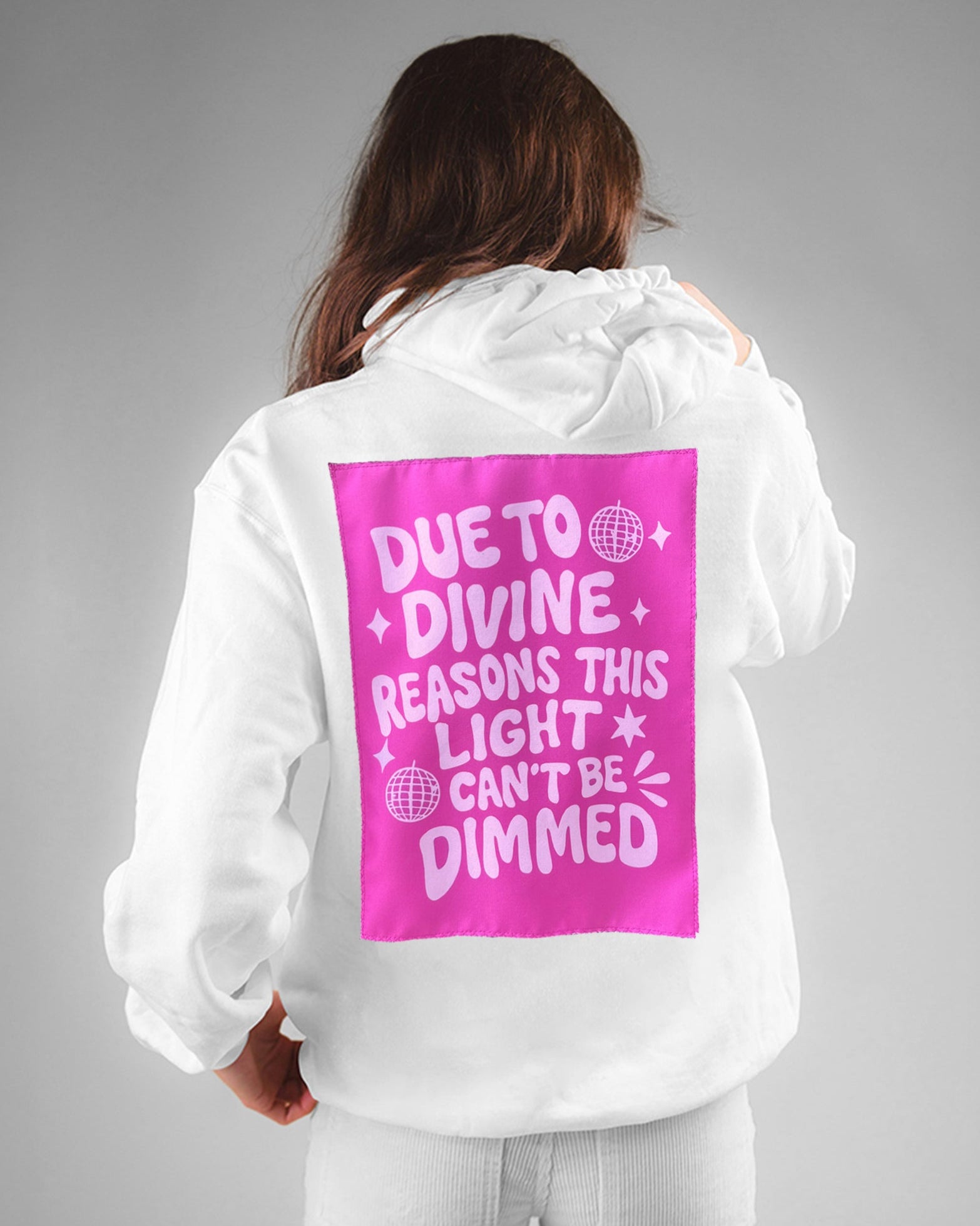 Person wearing a white hoodie with a pink back print on a gray background