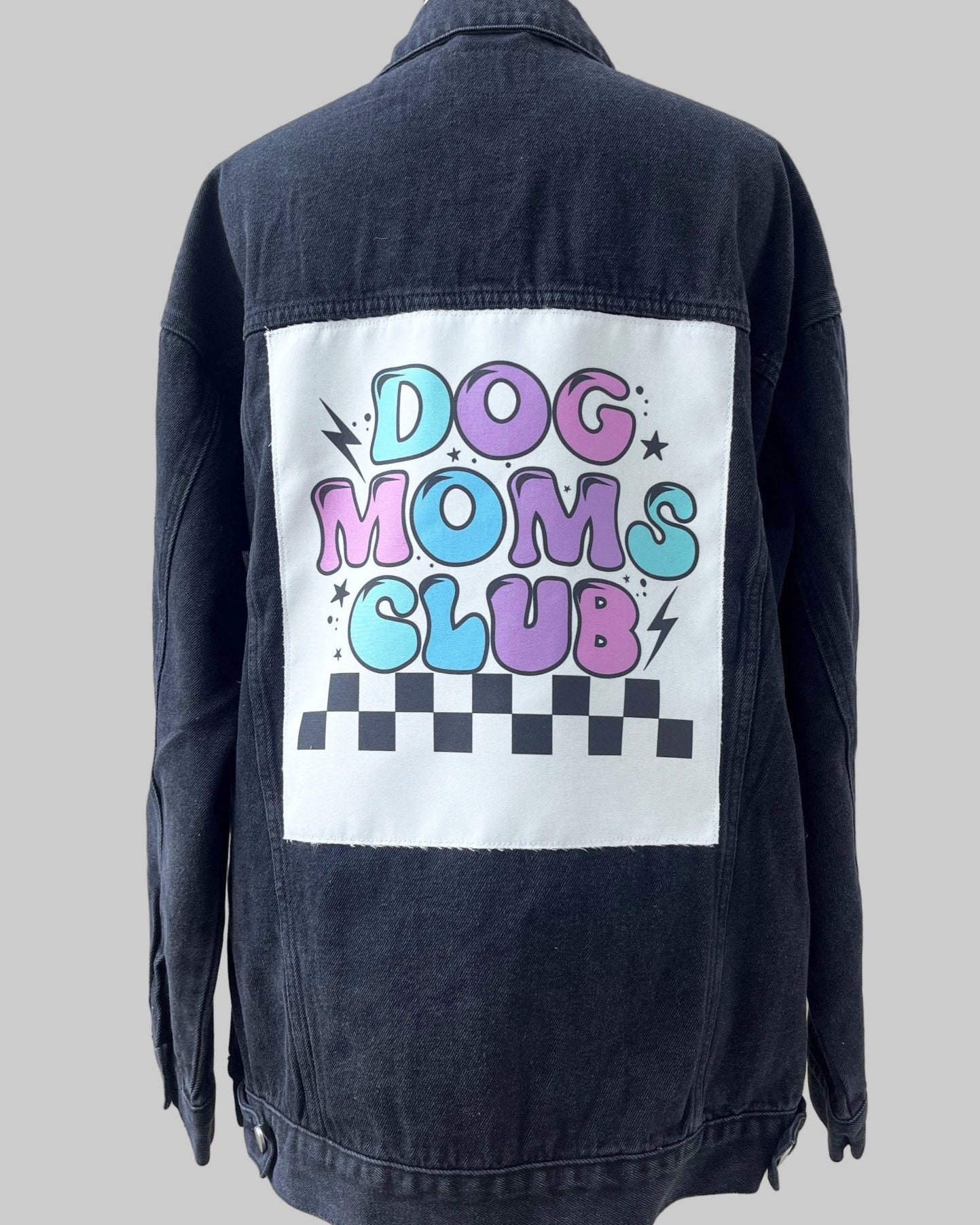 Black denim jacket with 'Dog Moms Club' graphic on a white background