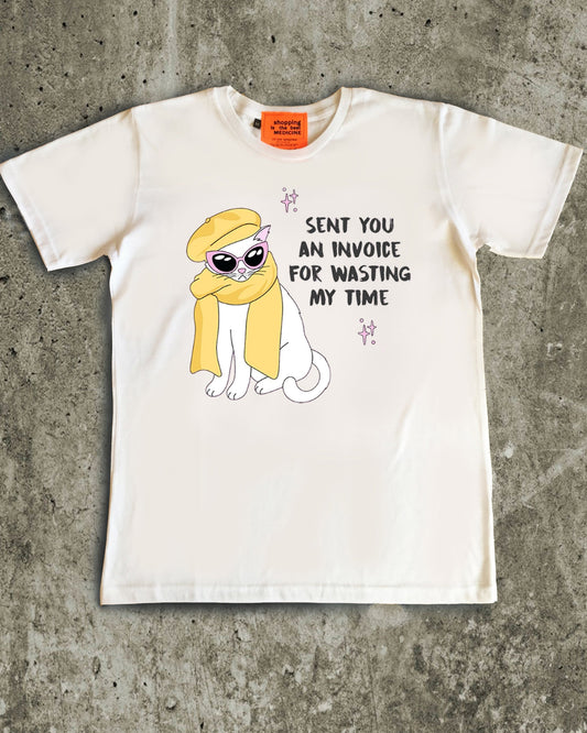 White t-shirt with a cartoon character and text on a concrete surface