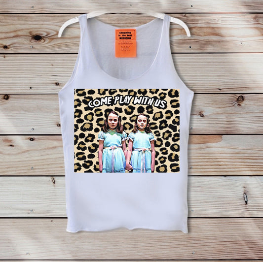 White tank top with leopard print graphic and text 'COME PLAY WITH US' on a wooden background