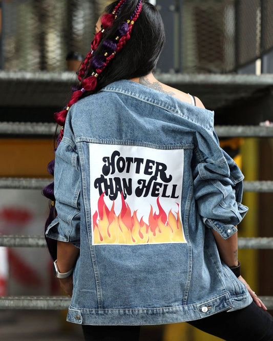 Person wearing a denim jacket with 'Hotter Than Hell' graphic on the back.