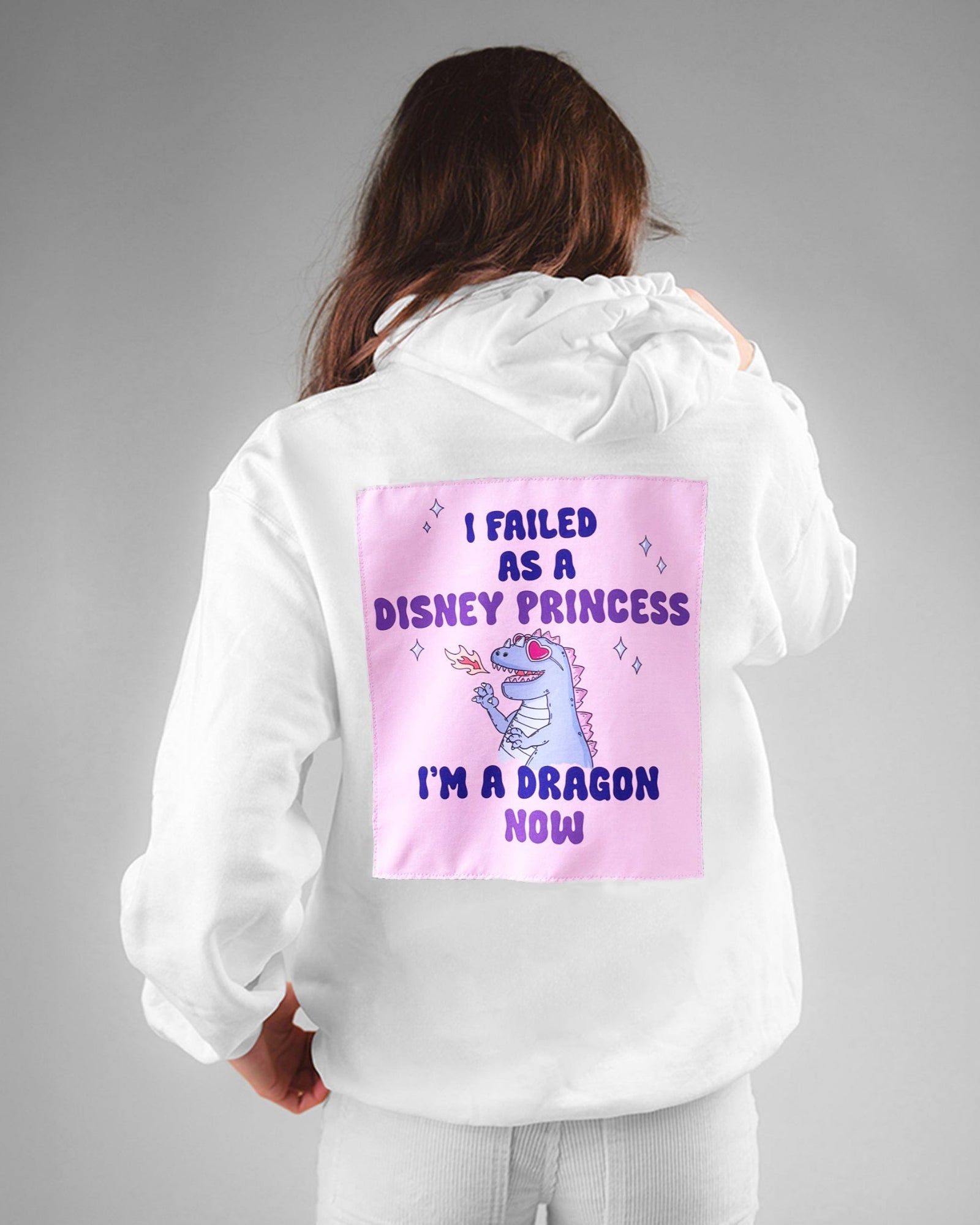 Person wearing a white hoodie with a colorful graphic and text on the back, on a gray background