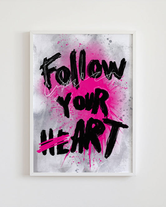 Framed artwork with 'Follow Your Heart' text on a pink and gray background