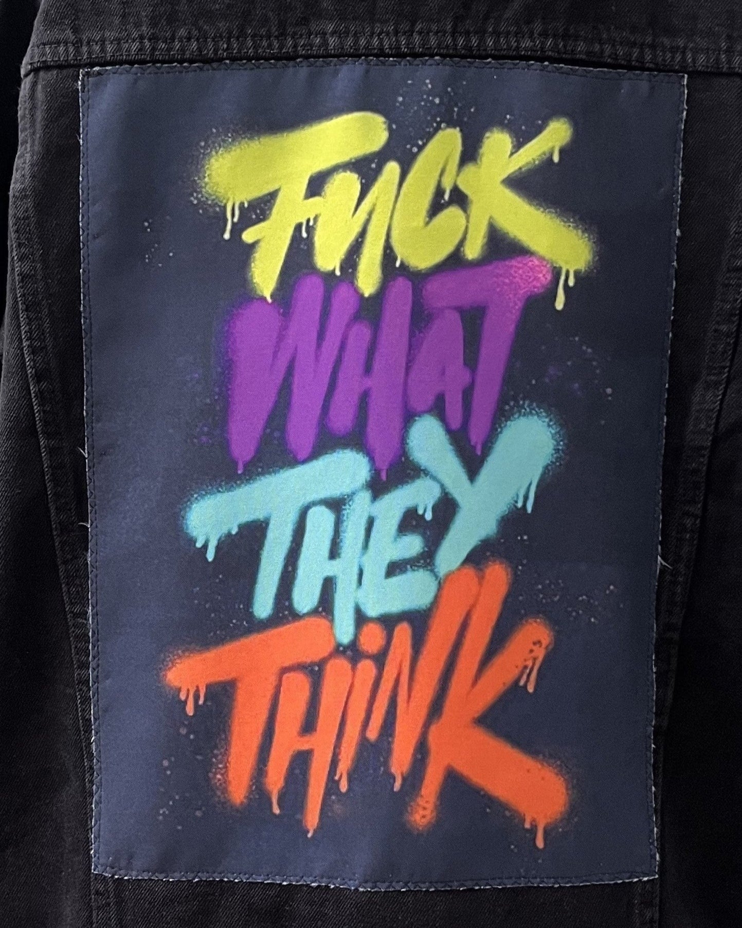 Text 'Fuck What They Think' in colorful graffiti style on a dark background