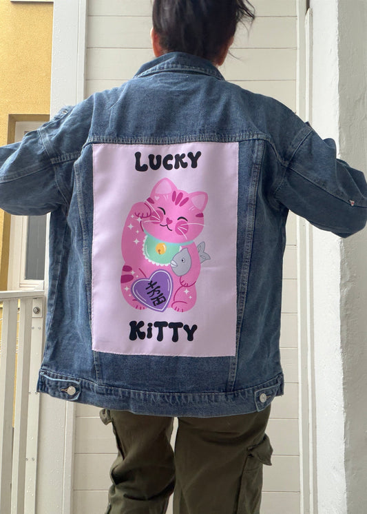 Denim jacket with a pink cartoon character and text on a white background