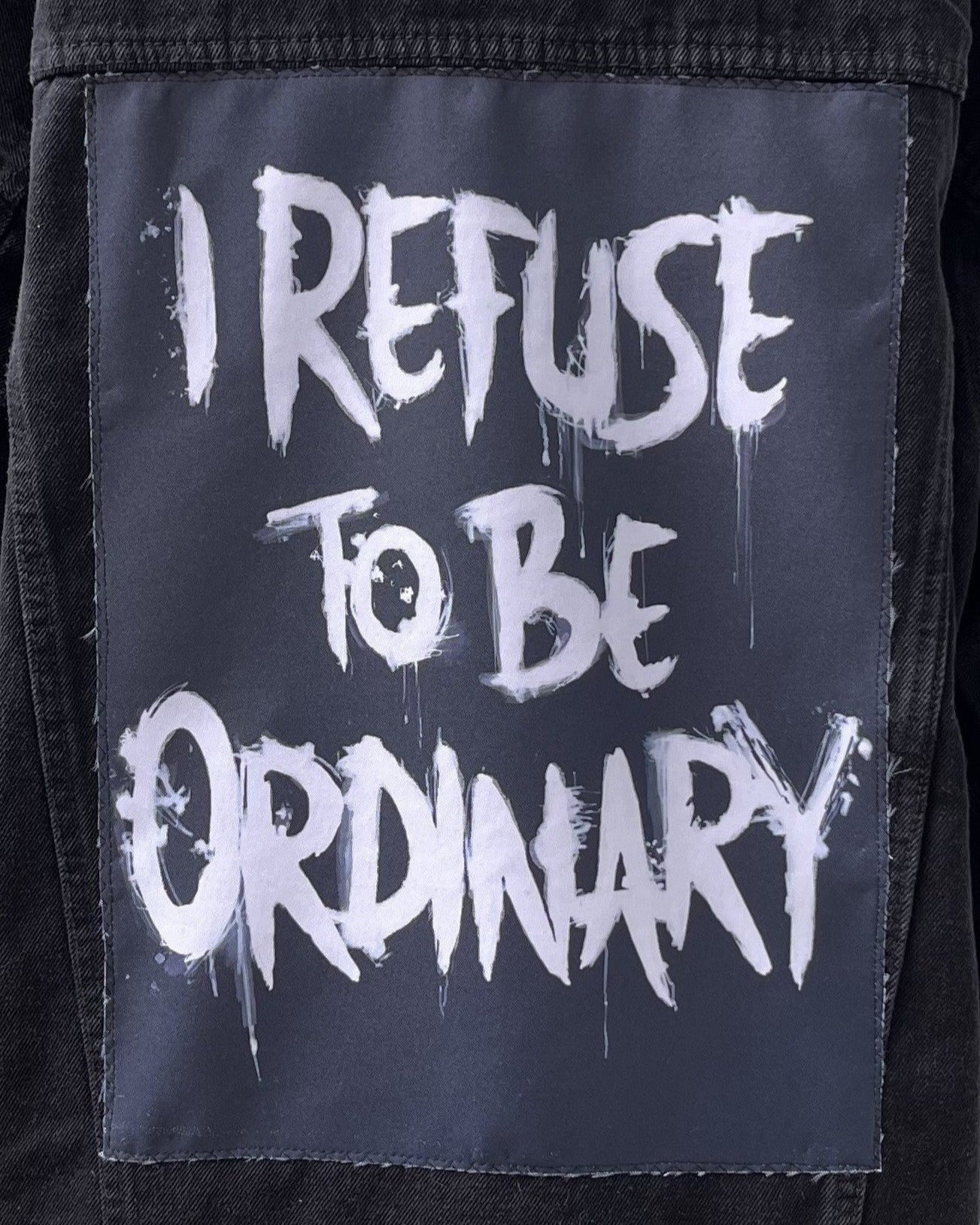 Text 'I REFUSE TO BE ORDINARY' on a black background