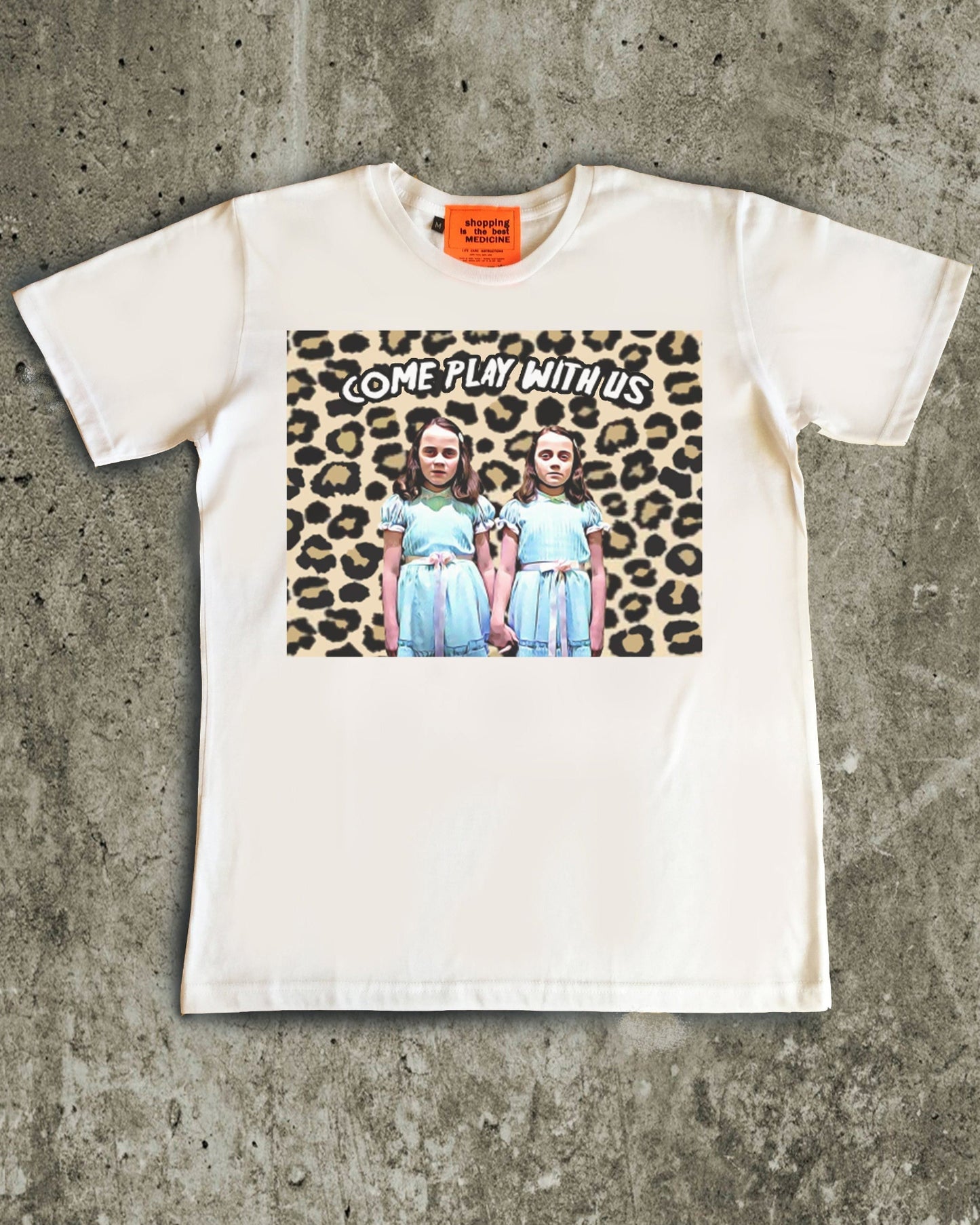 White t-shirt with graphic design on a concrete surface
