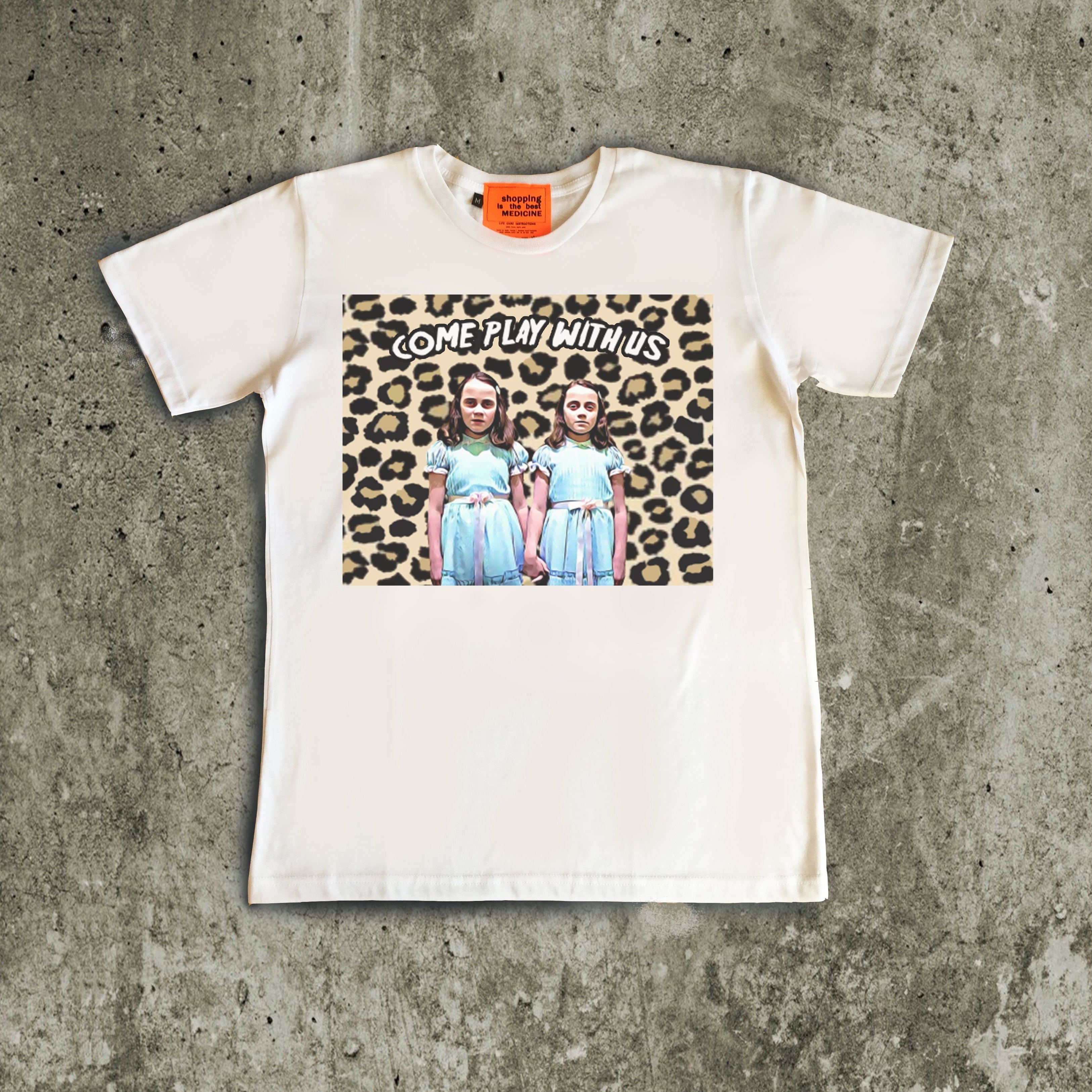 White t-shirt with graphic design on a concrete surface