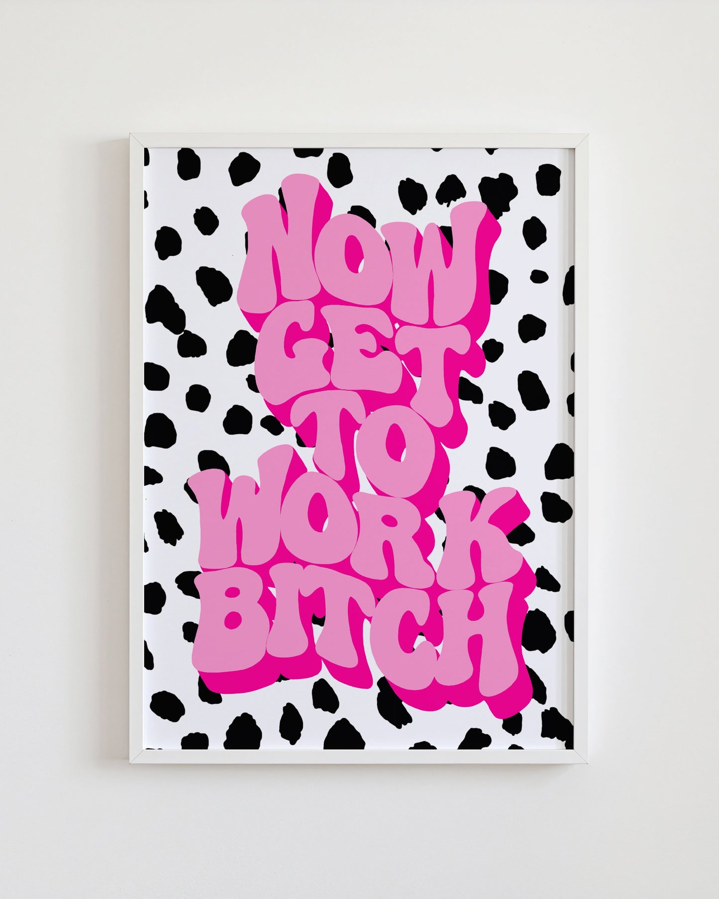 Framed artwork with pink text on a black and white polka dot background